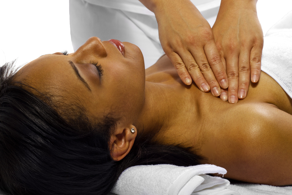 therapist/masseuse treating a young black female client